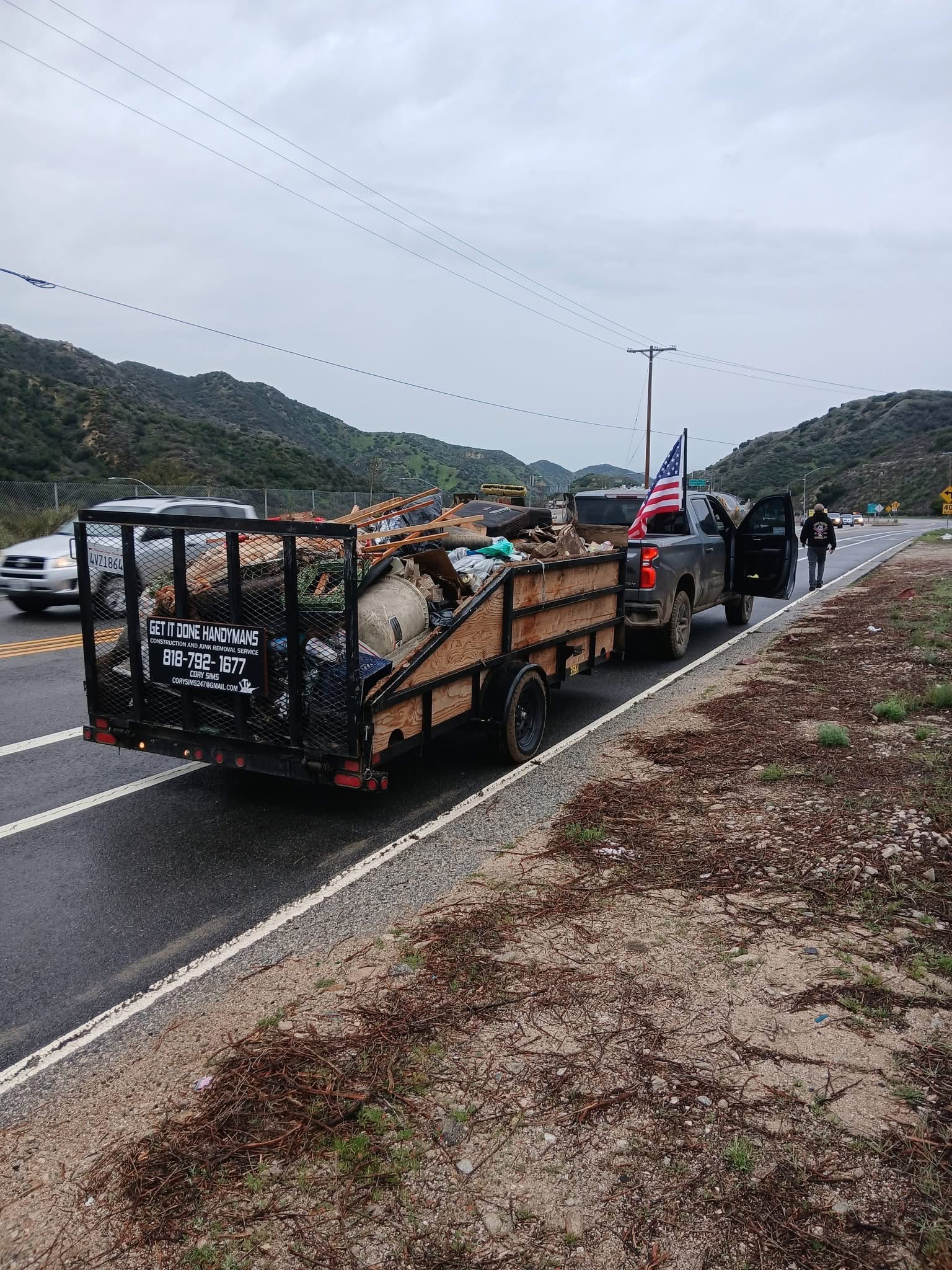 Get It Done Handymans branded trailer loaded with junk removal