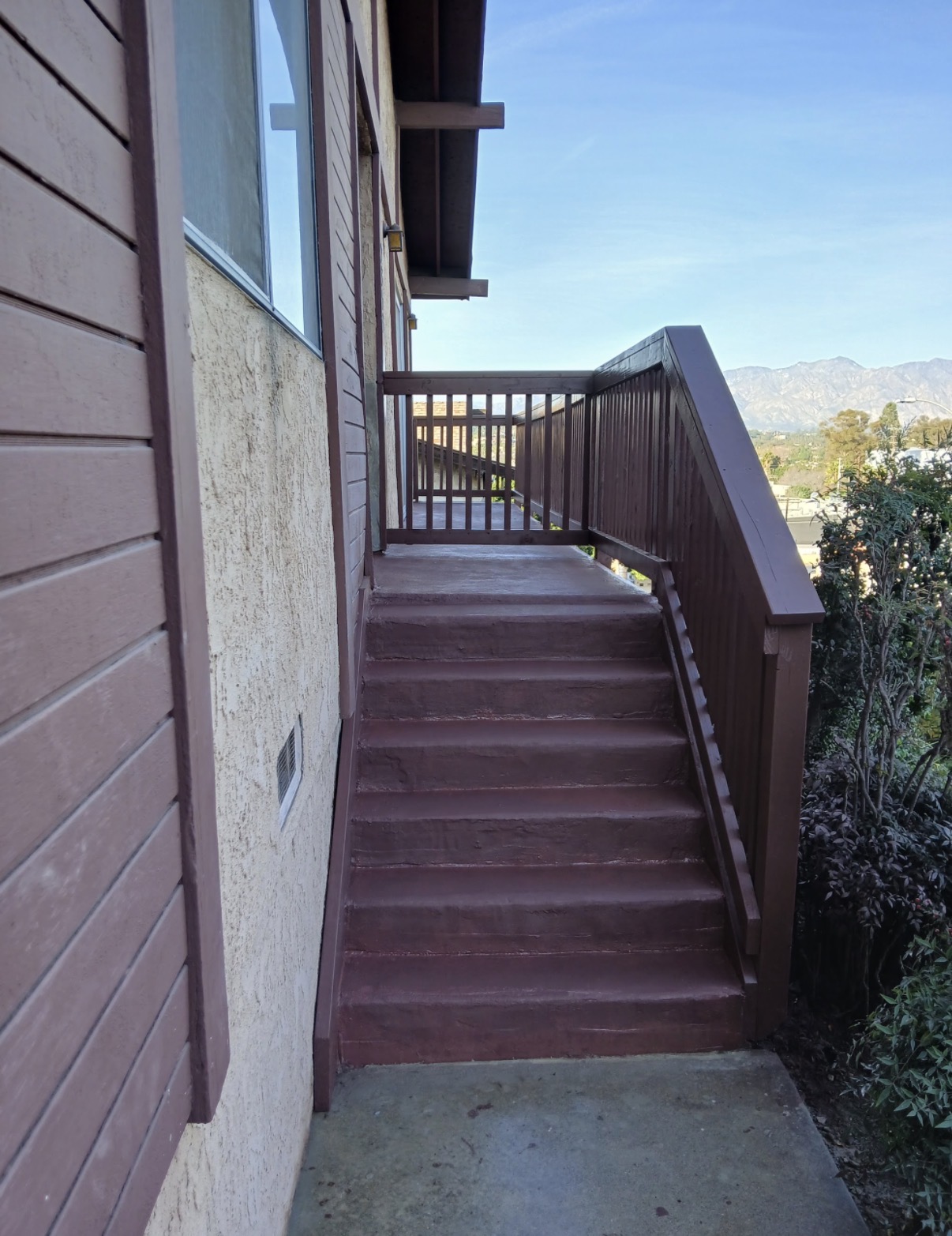 New stained brown stairs and railing