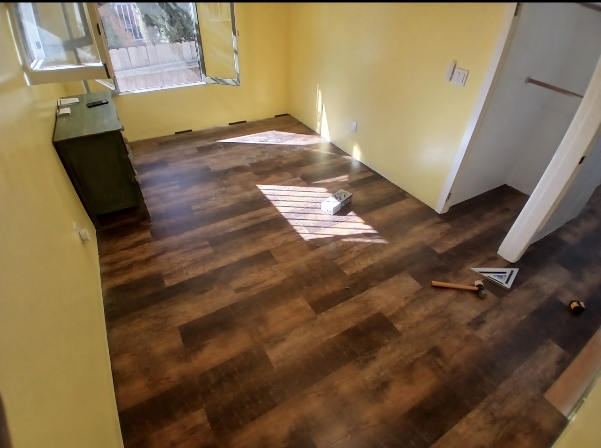 Finished bedroom with dark wood-look plank floors