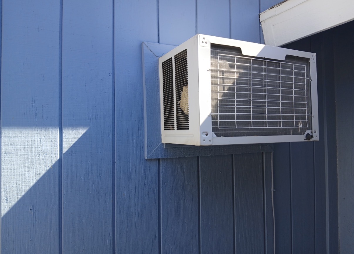 Old AC unit in window opening